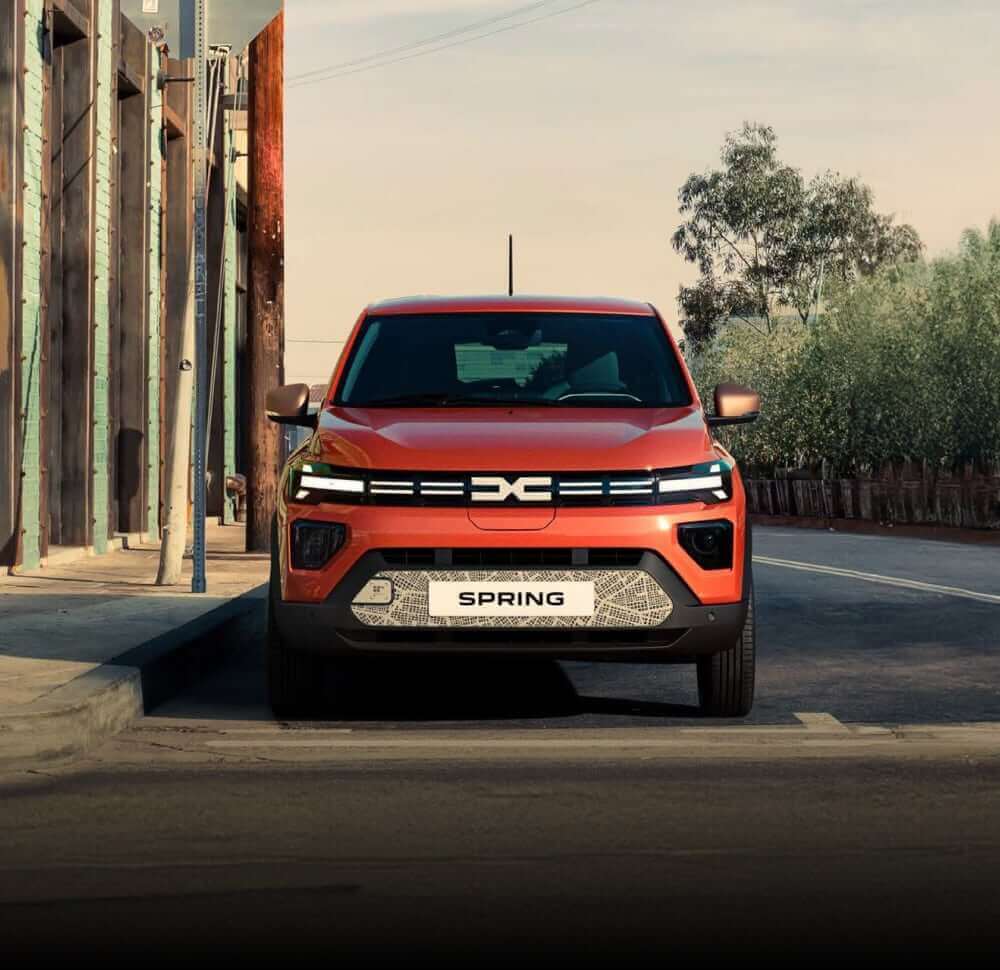 Front view of Dacia Spring parked in street background